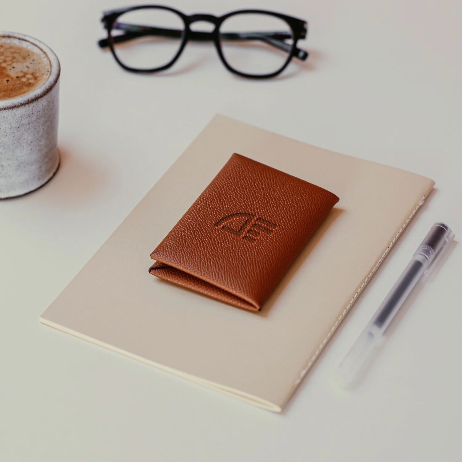 Accountable Finance mark embossed on a tan leather card wallet