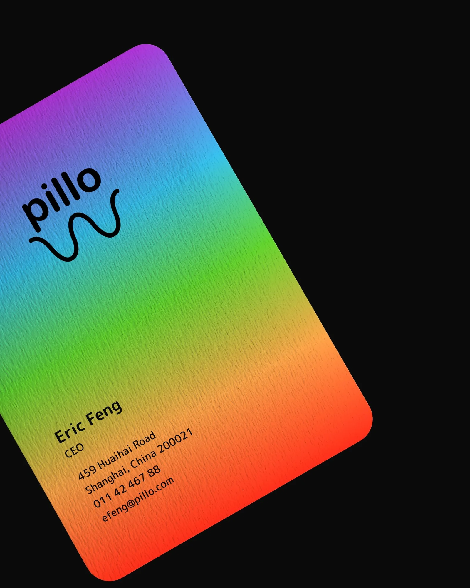 pillo business card for Eric Feng, CEO, printed on textured stock with the pillo spectrum gradient and black logo